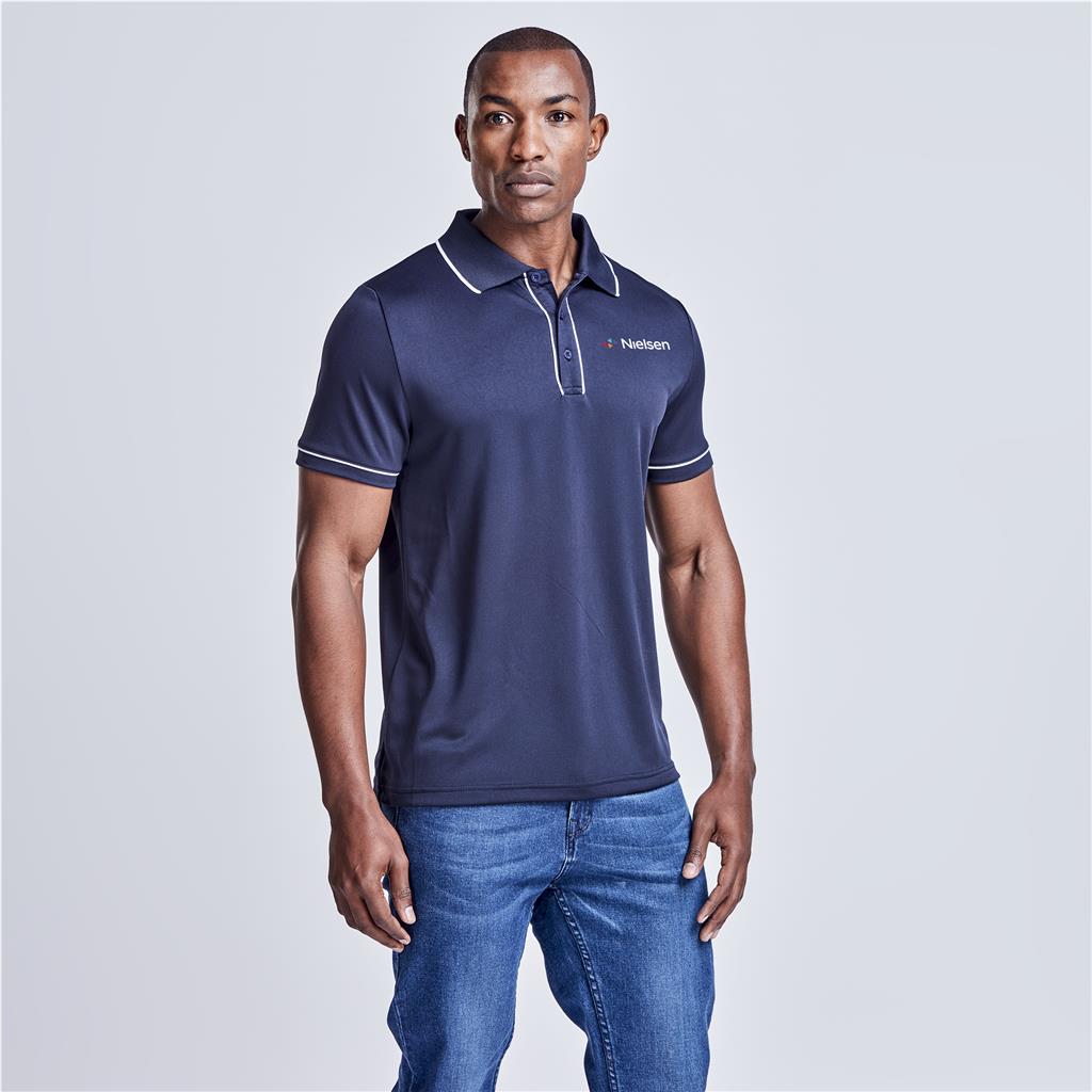 Male model wearing a navy branded polo shirt.