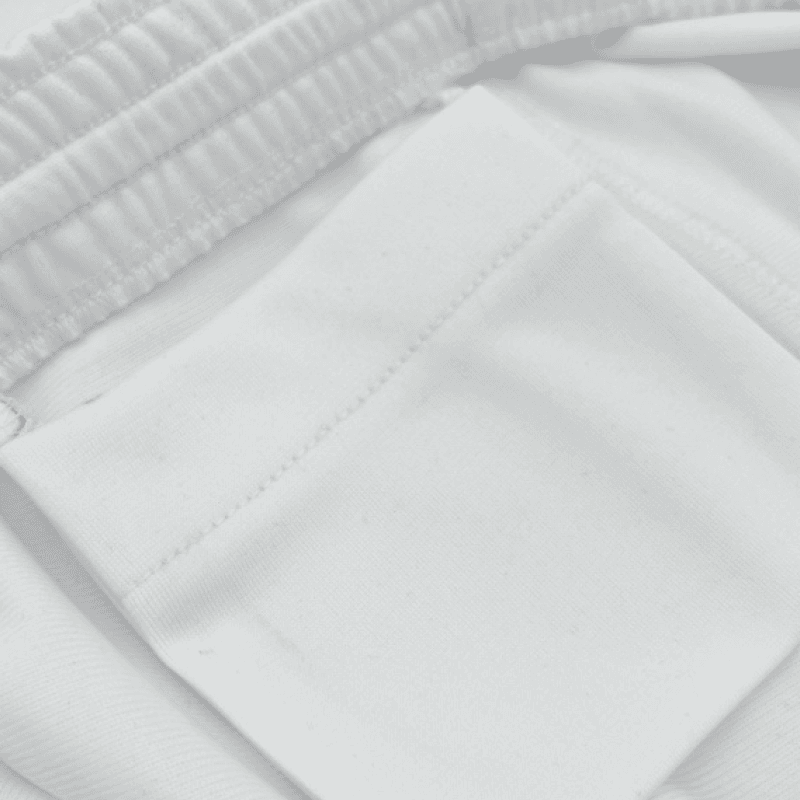 Close-up of white sports fabric and waistband detail.