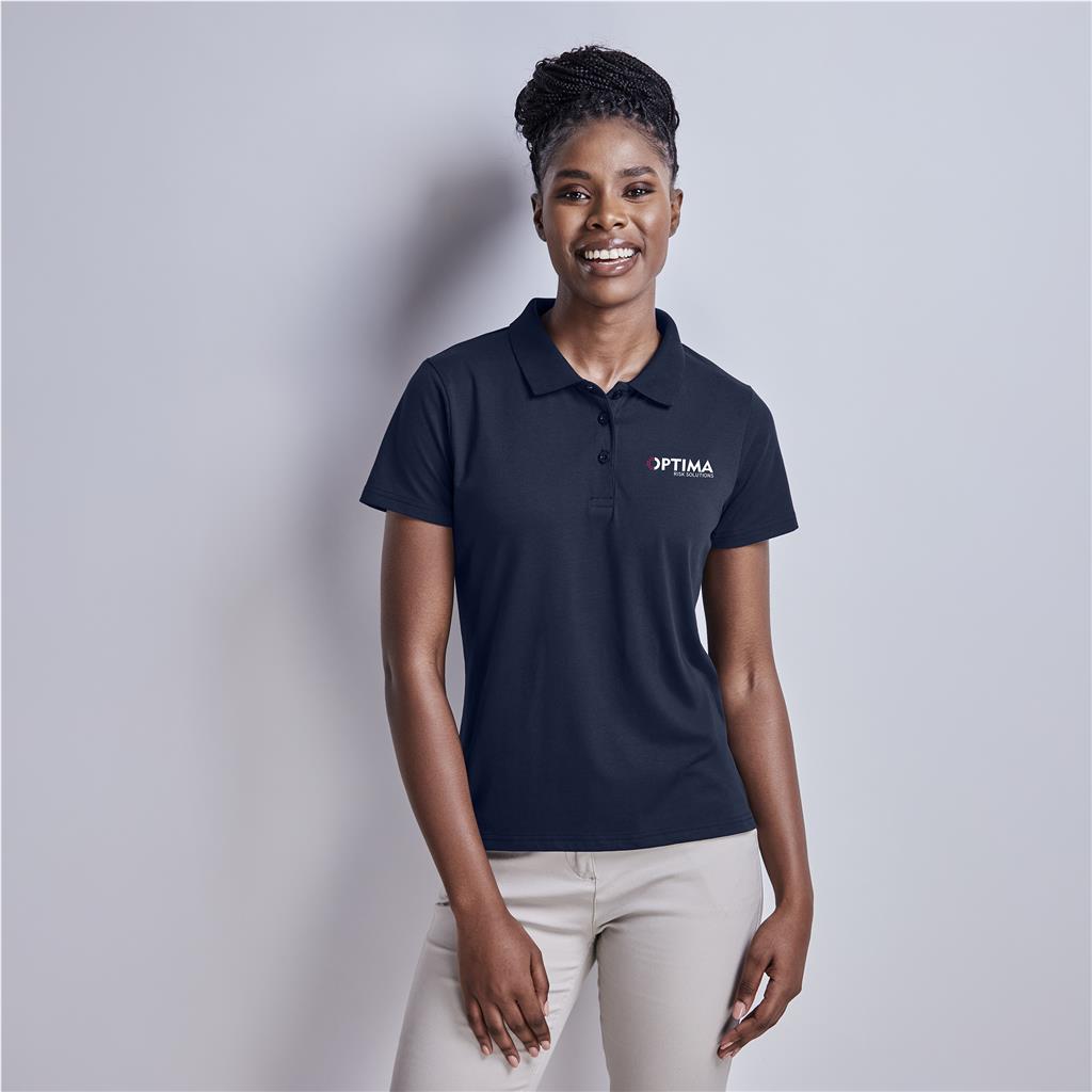 Female model wearing a navy branded golf shirt.