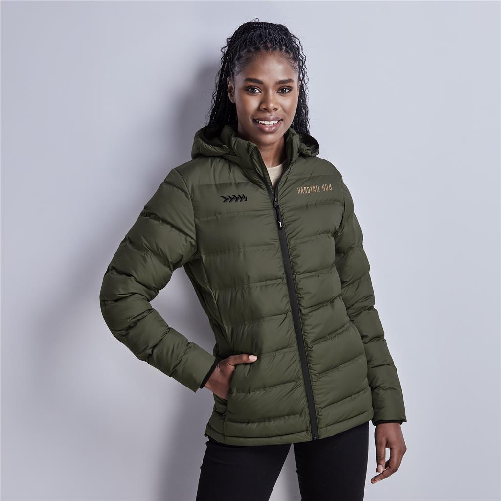 Female model wearing an olive green puffer jacket with hands in pockets.