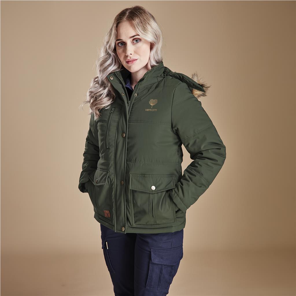 Female model wearing an olive green parka jacket with hands in pockets.