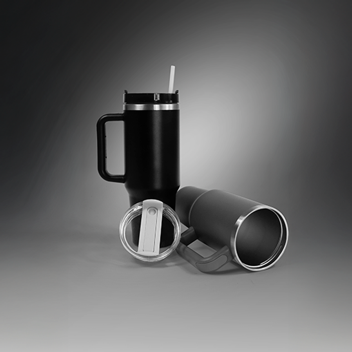 Black insulated travel tumbler shown with lid and reusable straw.