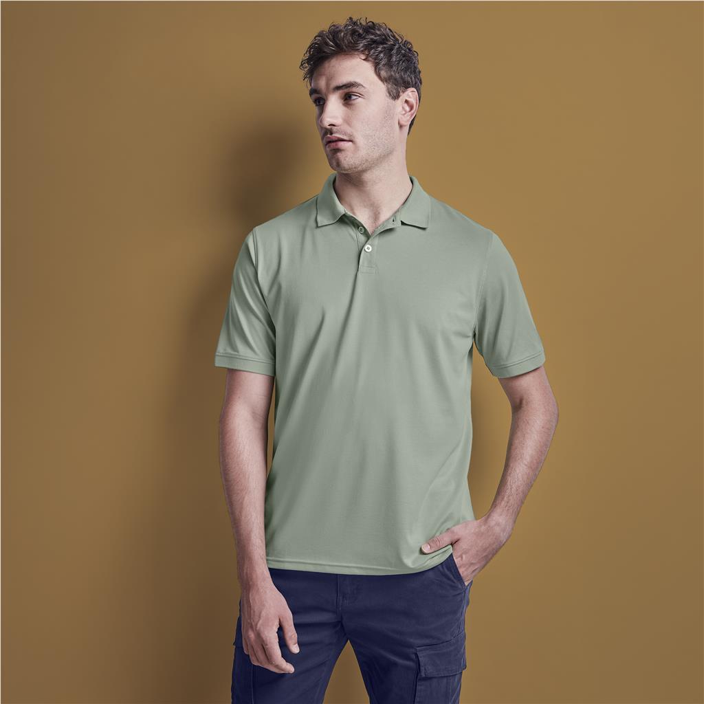 Male model wearing a sage green Mainline Sportswear golf shirt.